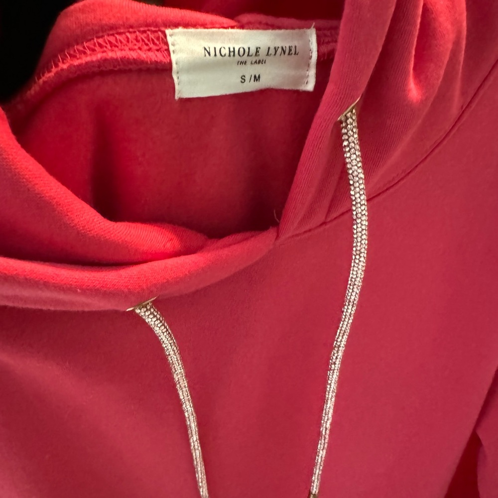 Hoodie dress with feather and bling. New and never worn but removed the tags.